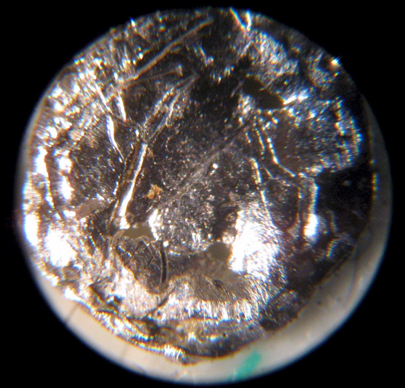 Americium — A small disc of Am-241 under the microscope.
