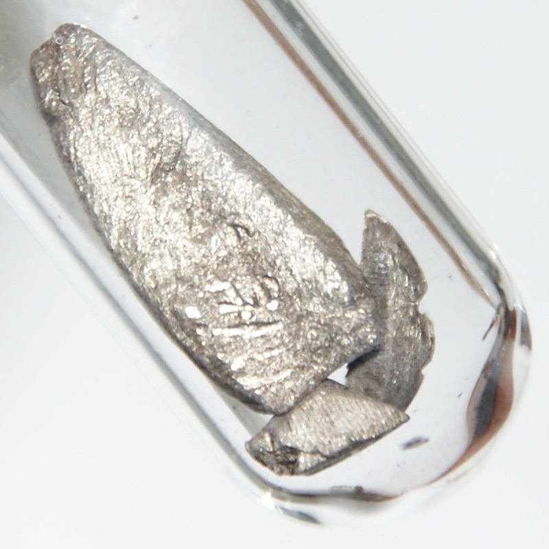 Europium — Weakly Oxidized Europium, hence slightly yellowish. 1.5 grams, large piece 0.6 x 1.6 cm.